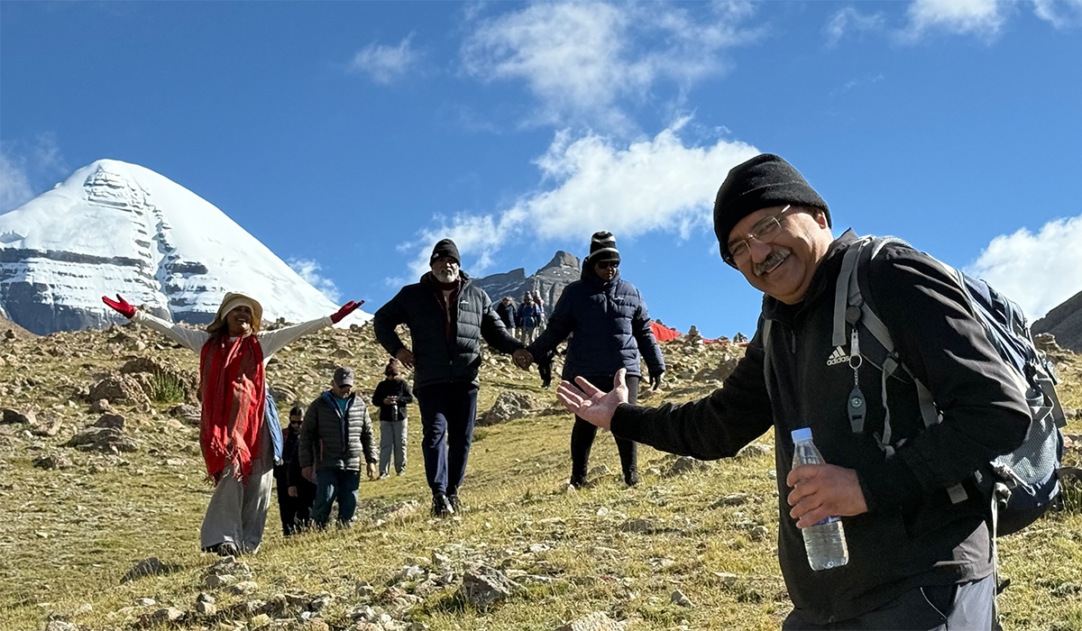 Reisende auf der Kailash-Kora mit Mount Kailash im Hintergrund