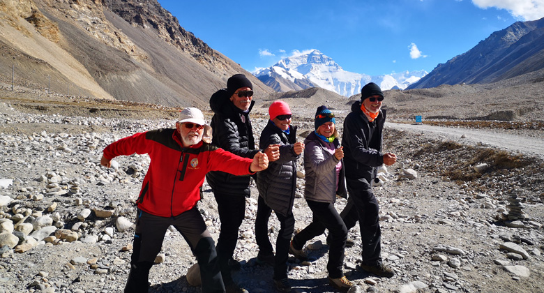 A group of senior travelers visit Everest Base Camp