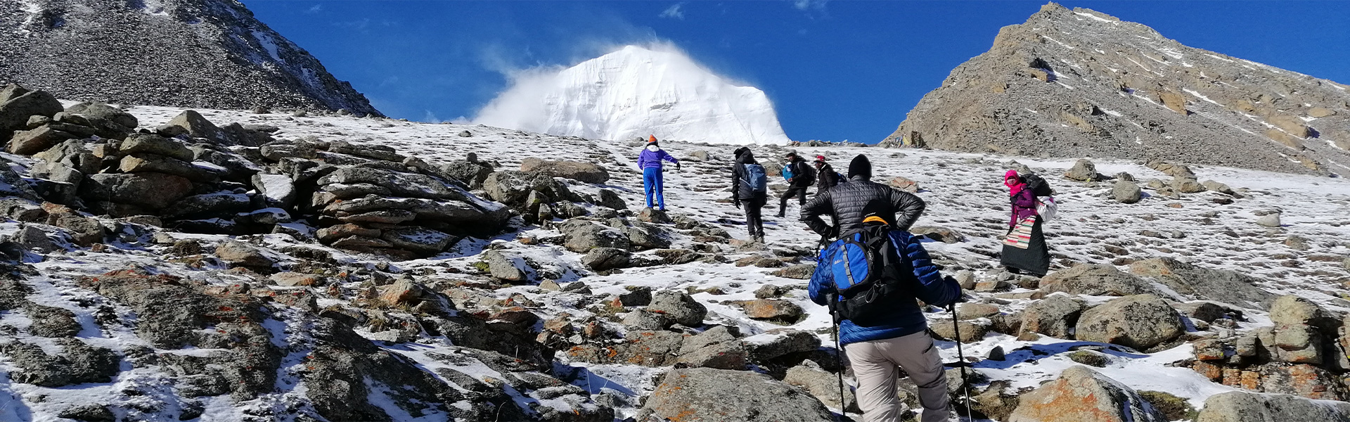 Reisende beim Trekking am Mount Kailash auf einer verschneiten Hochgebirgsroute
