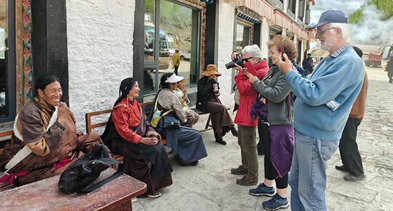 Tourists connect with friendly Tibetans